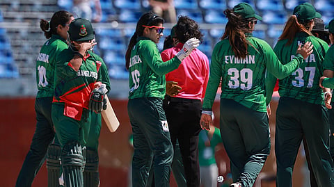 Pakistan players celebrate as a Bangladesh player (L) looks dejected after the women’s bronze medal match at the 2026 Asian Games.