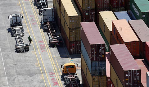 Workers stack empty shipping containers for storage at Wando Welch Terminal operated by the South Carolina Ports Authority in Mount Pleasant, South Carolina, US May 10, 2018. Picture taken May 10, 2018.