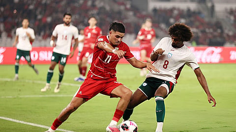 Indonesia's Ragnar Oratmangoen is challenged by Bangladesh's Hamza Choudhury during their FIFA ASEAN Cup Division 1 Group A match.