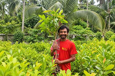 Ratul Munshi with a sapling
