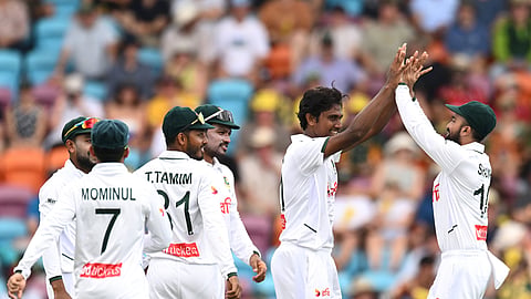 Bangladesh pacer Hasan Mahmud celebrates a wicket with teammates.