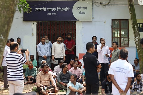 CUET teachers, officials and employees stage a sit-in at Sonali Bank’s CUET branch on Wednesday, protesting the delay in payment of their salaries and allowances.