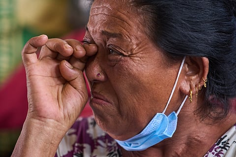 Sabitri Tamang, whose six family members are missing after recent floods, breaks down while sitting inside a temporary shelter set up at a school in Nepal's Nuwakot district, Tuesday, Sept 8, 2026.