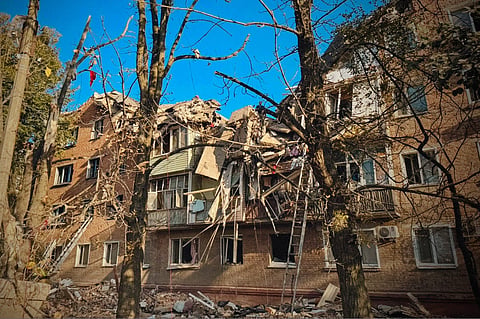 In this photo provided by the Ukrainian Emergency Service, rescuers work on the scene of a building destroyed following recent Russian attacks in Pryluky, Chernihiv region, Ukraine, Wednesday, Oct 7, 2026.