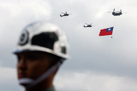 Taiwan military CH-47 Chinook and UH-60M Black Hawk helicopters fly over Taipei as the CH-47 Chinook carries a giant national flag during National Day celebrations in Taipei, Taiwan, October 10, 2026
