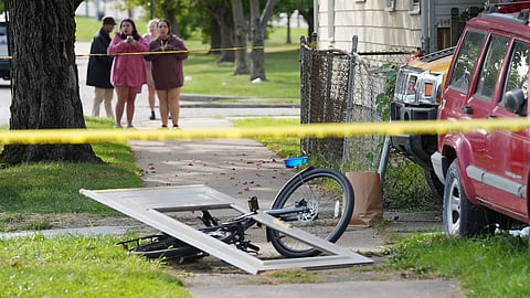 Bystanders gather near a house where nine people were confirmed dead in what was described as a mass shooting in Erie, Pennsylvania, US October 10, 2026