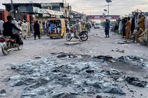 People gather on a street near the National Database and Registration Authority (NADRA) office following clashes, in Bara of Pakistan's Khyber-Pakhtunkhwa province on Oct 14, 2026.