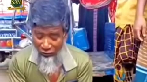 Md Sadullah tears and eats a live myna bird over a 500 taka bet in Madarganj, Jamalpur.