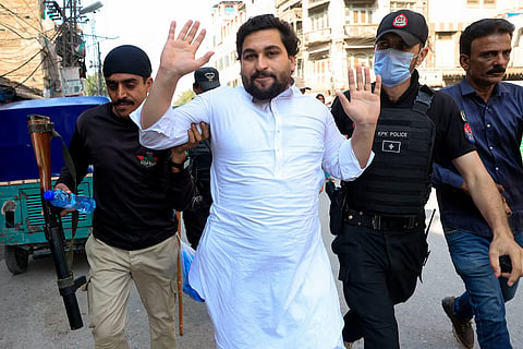 Police officers detain a protester following a protest call by supporters of jailed former Pakistani Prime Minister Imran Khan's party, Pakistan Tehreek-e-Insaf (PTI), a day after Pakistan imposed a state of emergency in Khyber Pakhtunkhwa province and suspended the provincial government led by Khan's party, in Peshawar, Pakistan, October 12, 2026