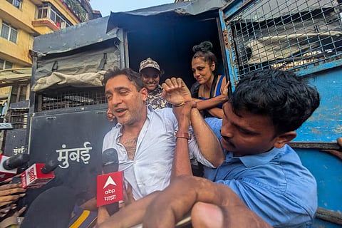 Bollywood actor Imran Khan is detained by security personnel during a protest by the Cockroach Janta Party (CJP) seeking the resignation of India's Chief Election Commissioner Gyanesh Kumar, in Mumbai, India, October 10, 2026.