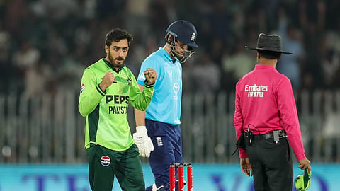 Pakistan's Arafat Minhas celebrates one of his six wickets against England.