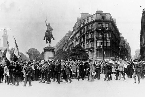 French war veterans march past the Washington Monument on the Place d'Iena in Paris, on July 19, 1926, in protest against the US debt terms.