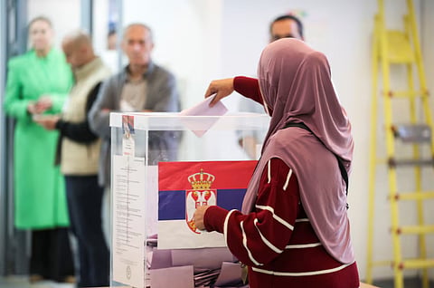 A woman votes at a polling station during the parliamentary election in Belgrade, Serbia on October 25, 2026.