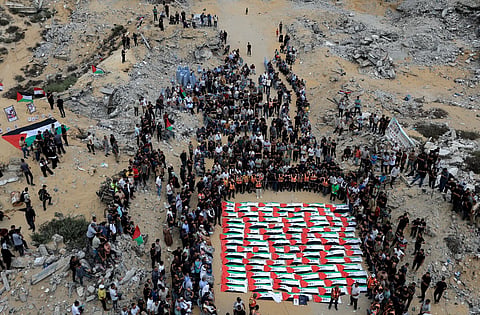 Mourners attend a mass funeral for Palestinians whose bodies were recovered from the rubble of a residential building hit in an Israeli strike in October 2023, according to the Civil Defence, in Gaza City, October 1, 2026.