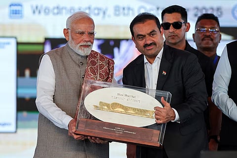 Indian businessman Gautam Adani presents a plaque to India's Prime Minister Narendra Modi during the inauguration of the Navi Mumbai International Airport in Ulwe, Raigad district, India, October 8, 2025