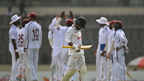 Bangladesh batter Tawhid Hridoy walks back after his dismissal as the West Indies players celebrate in the morning session on Day 2 of the first Test at the Sher-e-Bangla National Cricket Stadium in Mirpur on Thursday.
