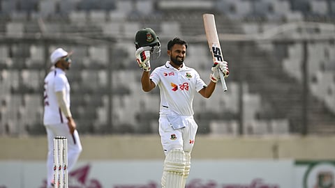 Shadman Islam raises his bat after completing his century on Day 2 of the first Test against West Indies at the Sher-e-Bangla National Cricket Stadium in Mirpur on Thursday.