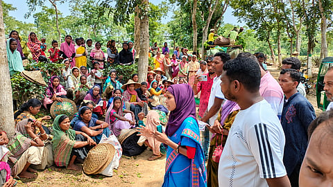 Khairun Akter, wearing a blue sari and purple headscarf, addresses a gathering of tea workers in Habiganj