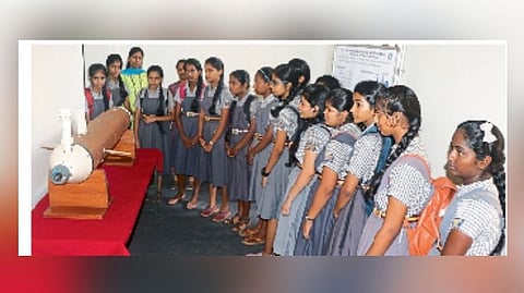 Students inspecting a packed exhibition at the Science Film Festival.