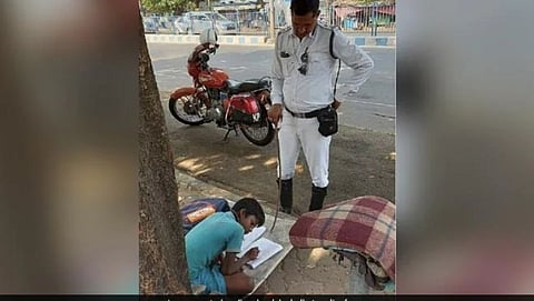policeman teaches 8 year old boy while managing traffic in kolkata post wins hearts