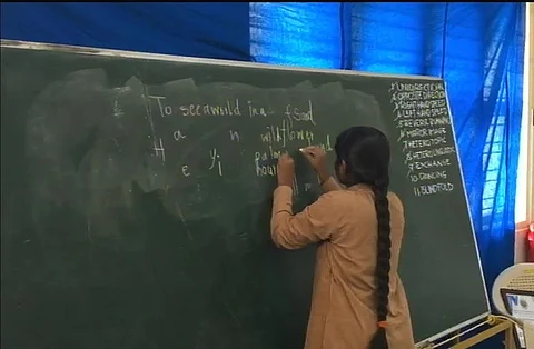 Aadi Swaroopa writing with both hands