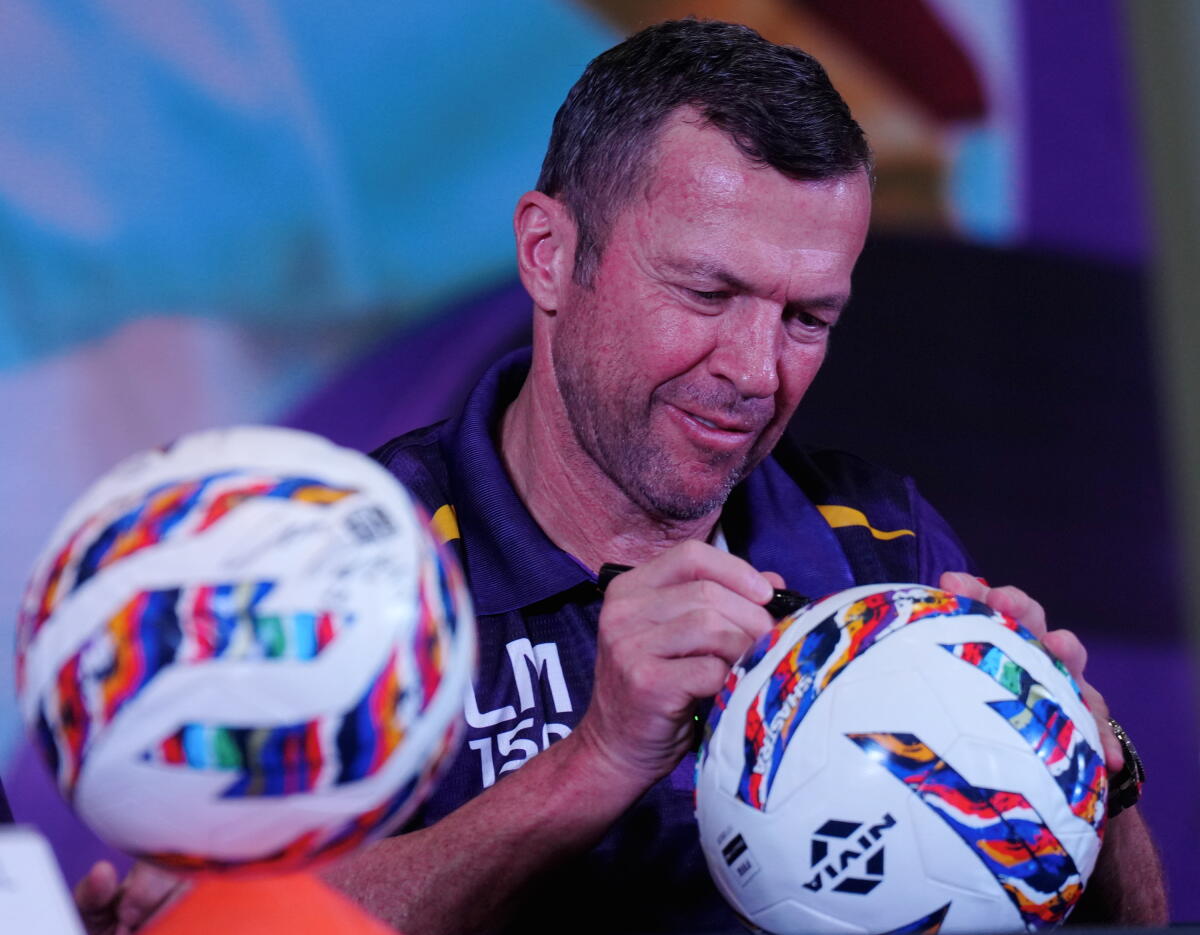 Former German footballer and Official Ambassador of the Bengal Super League (BSL) Lothar Matthaus signs a football during BSL press conference, at South City International School, in Kolkata, West Bengal.