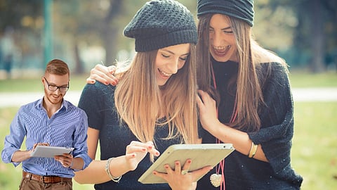 three people using tablet devices