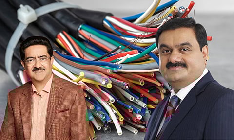 cable in the back ground and pictures of Gautham Adani and Kumar Mangalam Birla.