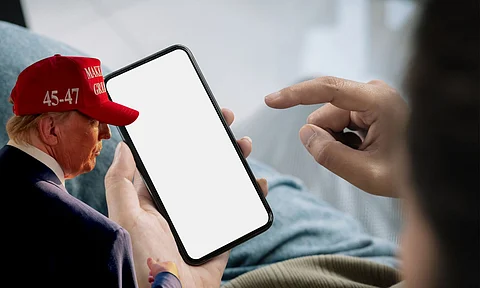 A person using social media in their phone and US president Donald trump
