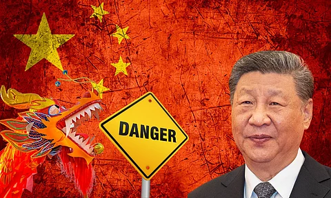 A digitally created graphic showing Chinese President Xi Jinping on the right, a traditional Chinese dragon on the left, and a bold yellow "DANGER" road sign in the centre. The background features the Chinese national flag with a distressed red texture, symbolising rising global concerns or warnings related to China.