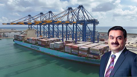 Large Maersk container ship docked at a port with cranes unloading cargo containers. In the foreground, an Indian businessman (Gautam Adani) in a suit is smiling, with the port and sea in the background
