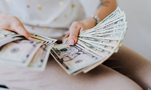 Person Holding Fan of Us Dollar Bills