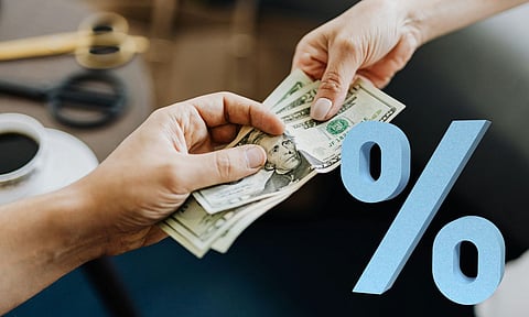 Hands Holding Us Dollar Bills and percentage symbol