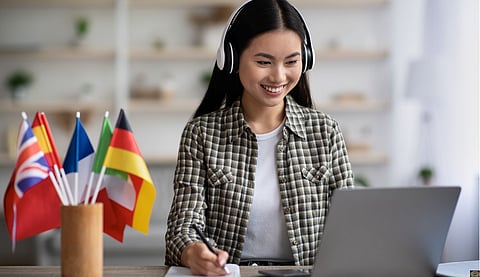 Happy asian woman learning foreign language online
