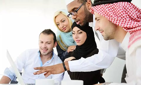 UAE personalities look at a computer