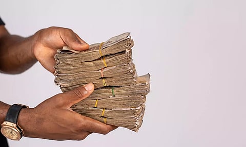 Currency note bundles in hand