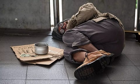 A poor man laying in the floor