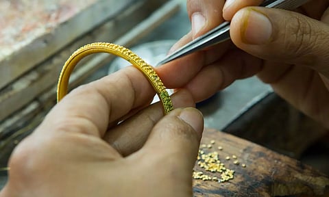 Gold ornaments in hand