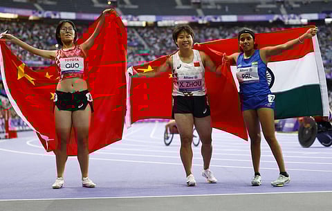 Xia Zhou of China celebrates after winning gold with silver medallist Qianqian Guo of China and bronze medallist Preethi Pal of India REUTERS/Stephanie Lecocq