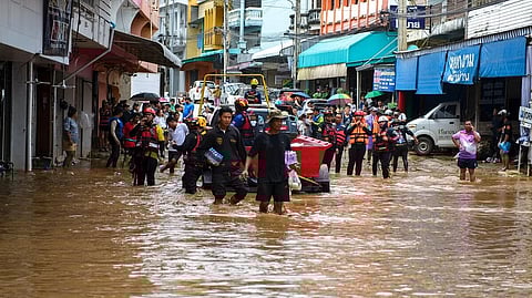 Rescue workers help stranded people from a flooded area at the border town of Mae Sai, following the impact of Typhoon Yagi, in the northern province of Chiang Rai, Thailand.