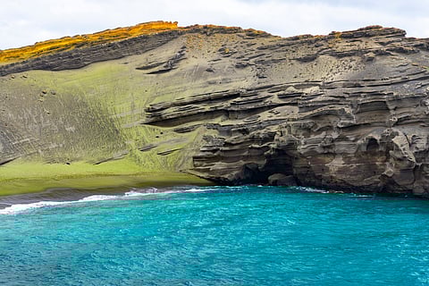 Why do green gems wash up in Hawaii?