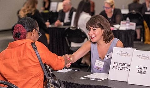 Michelle Orman, owner of Last Word Communications, meeting with an attendee at last year’s GIA New York Jewelry Career Fair. Photo © Mark McQueen.