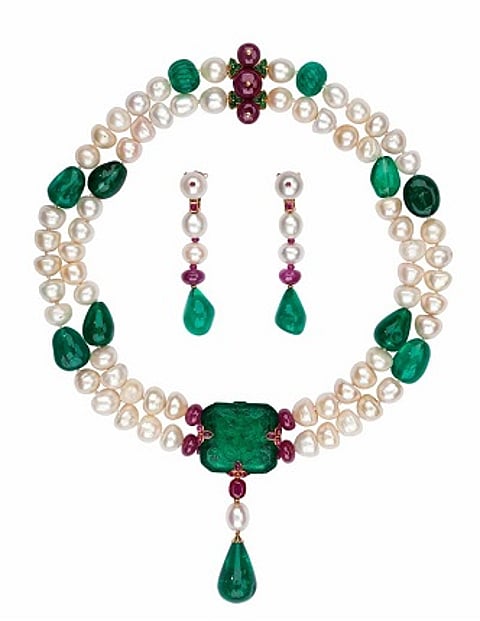 Cartier necklace made of pearls around and an extraordinary emerald stone. It was carved during the time of the Moghuls, in India (circa 17th century) This necklace has been made to commemorate the second Millennium, in the year 2000. Qatar Museum collections.