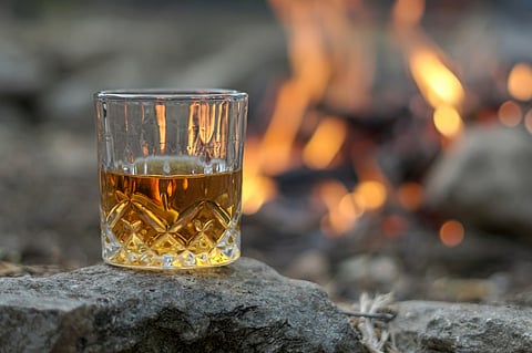 Glass of Whisky by the Fire. Photo by Thomas Park, unsplash