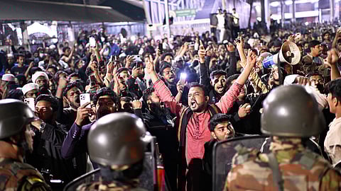 Protesters shout slogans in front of the premises of the Prothom Alo newspaper after news reached the country from Singapore of the death of a prominent activist Sharif Osman Hadi, in Dhaka, Bangladesh, Friday, Dec. 19, 2025.