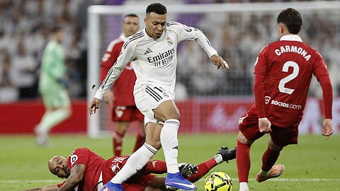 Kylian Mbappe controls the ball as defender Marcao Teixeira and Jose Carmona tackle him