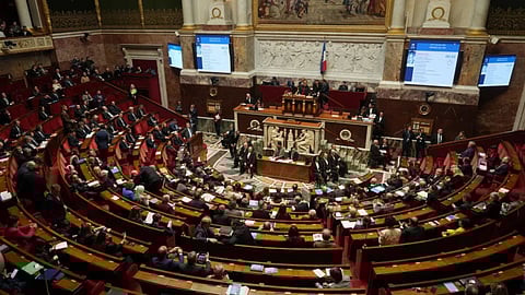 Parliament members sit as France’s National Assembly vote on a national health care budget that would suspend Macron’s unpopular pension reform raising the retirement age, in Paris, France (Photo: AP)
