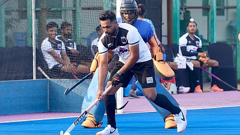 Harmanpreet Singh defends the ball during a exhibition match