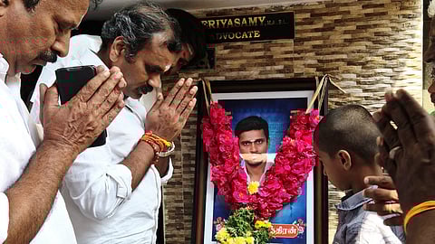Union minister and BJP leader L Murugan paying tributes to a portrait of a man who allegedly killed himself over the Deepam issue in Madurai on Tuesday