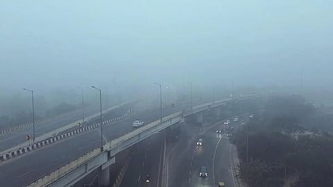 A drone view of Sarai Kale Khan as dense fog engulfs the area, in New Delhi